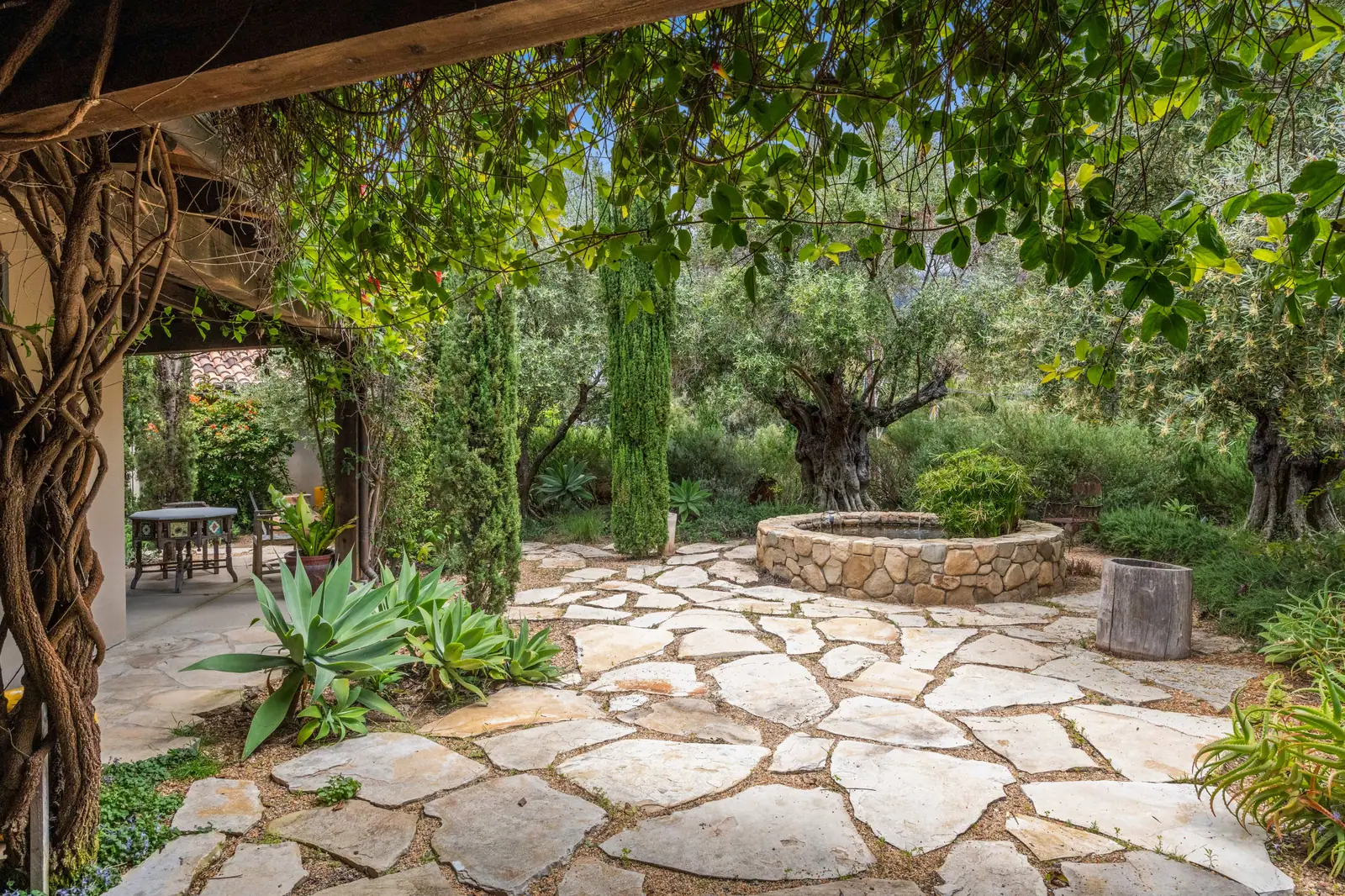 A stone patio and garden behind the Bayhouse