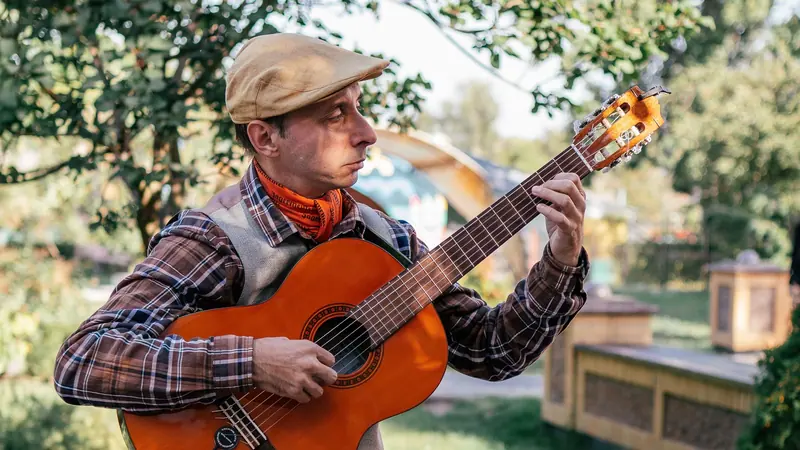 A resident playing guitar on the patio