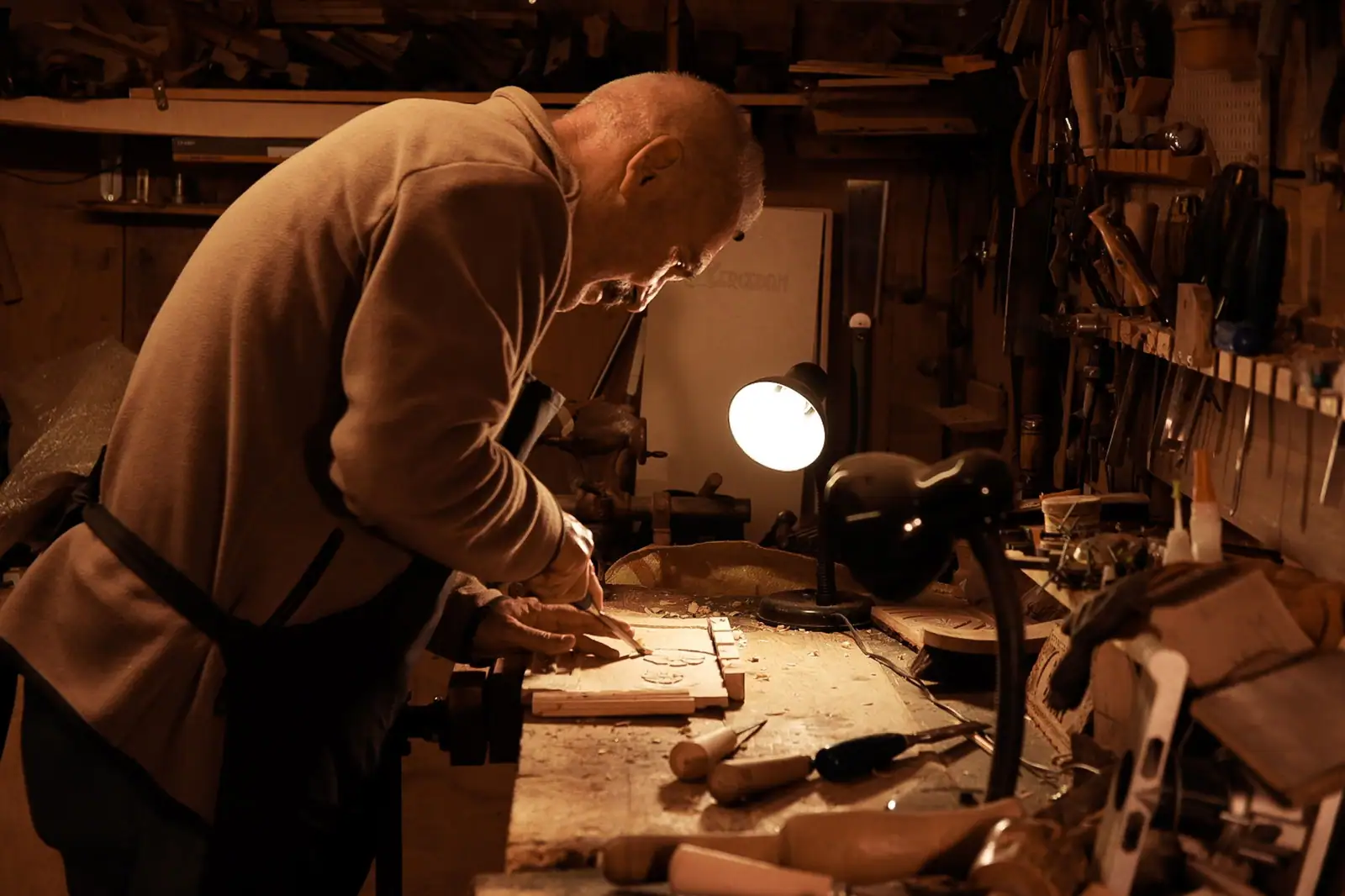 A resident carving walnut in the woodshop