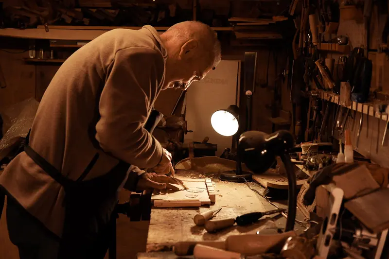 A resident shaping a piece of walnut in the woodshop