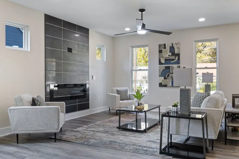 Stylish living room featuring a modern fireplace, sleek furniture, and artistic decor in a cozy setting.