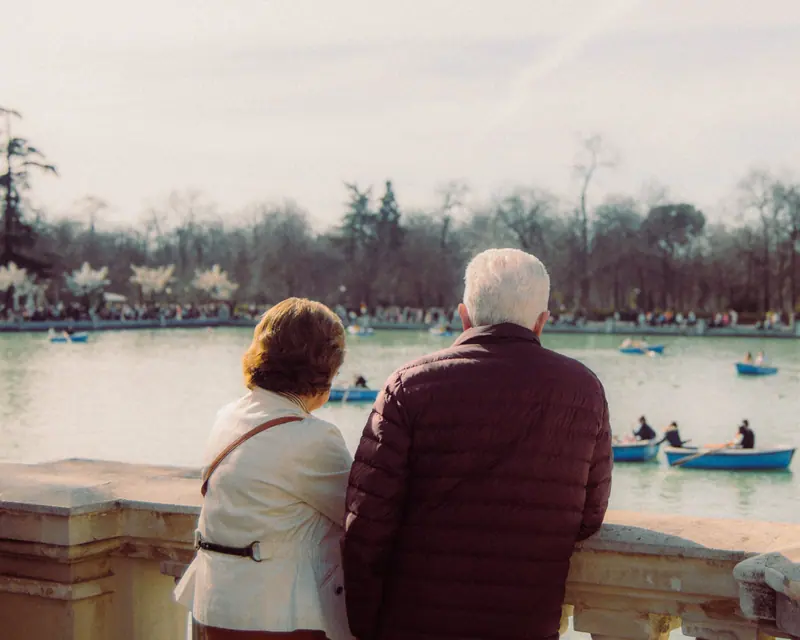 A couple watching the boats on the pond