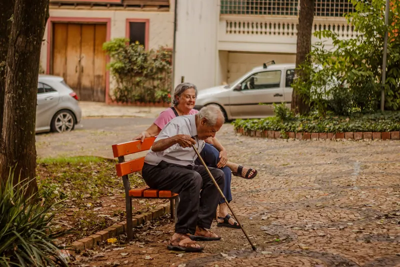 A couple resting on a park bench