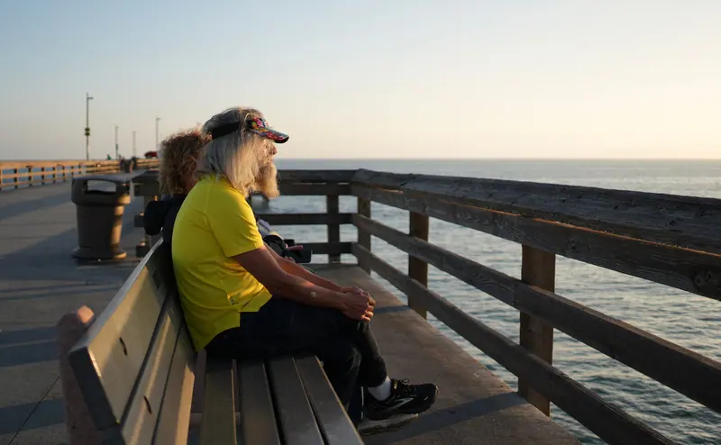 A resident watching the bay from the pier