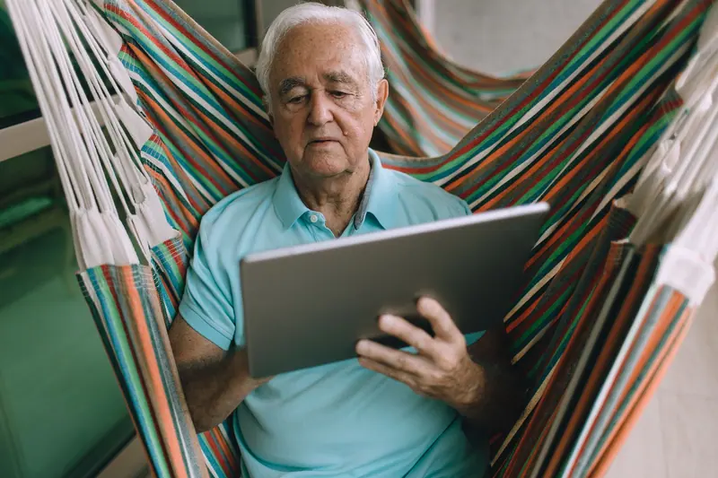 A resident relaxing with a tablet