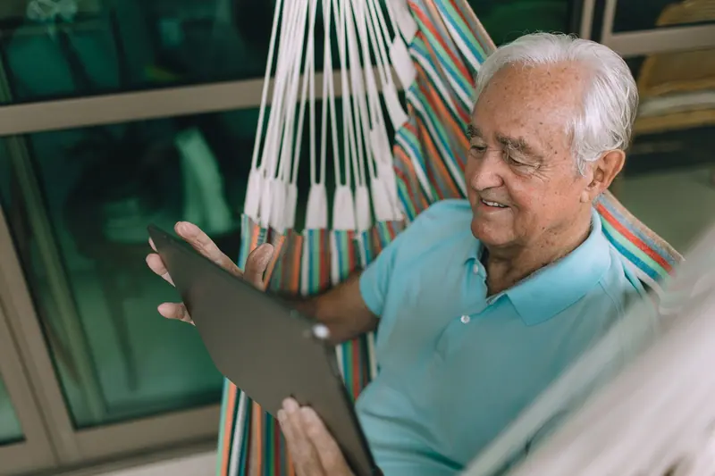A resident relaxing in a hammock on the sun porch