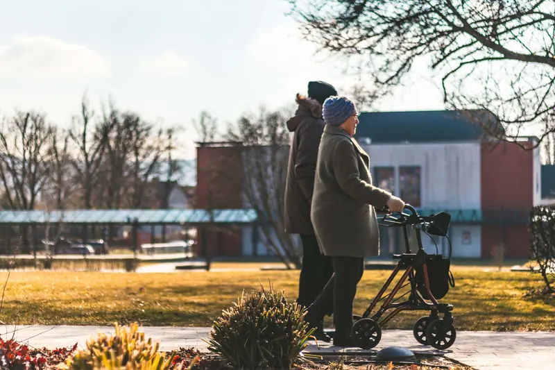 Two residents walking the trail together with a rollator