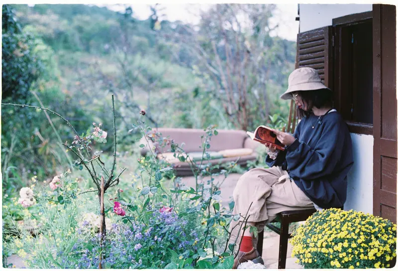 A resident reading among the flowers