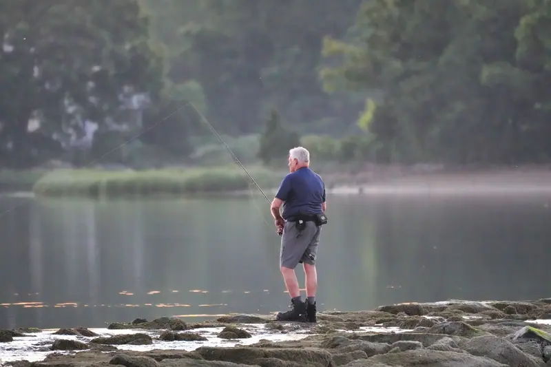 A resident standing at the water's edge on an early morning