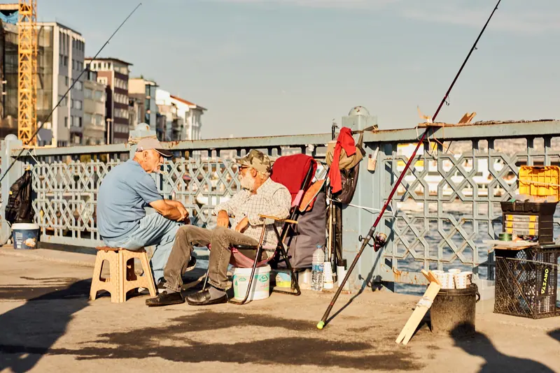 Two friends fishing off the bridge
