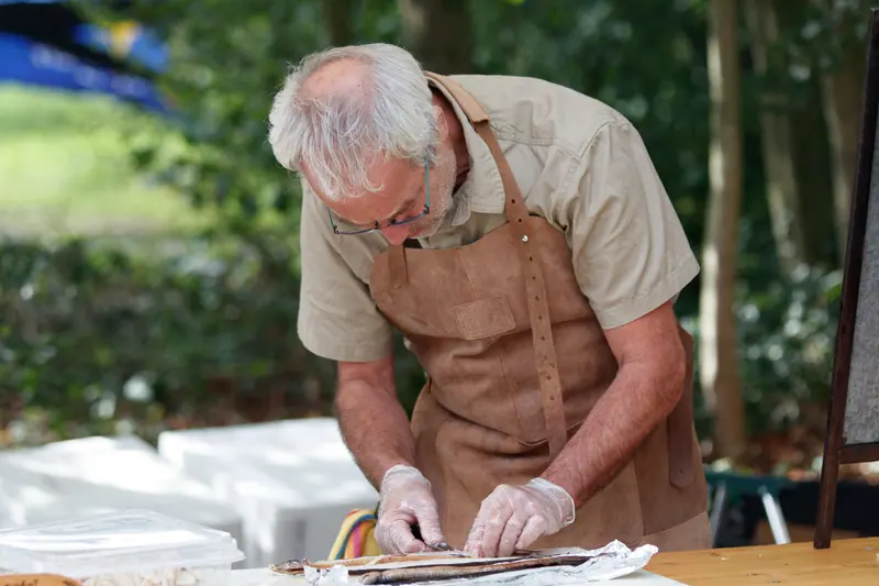 A resident making pie dough
