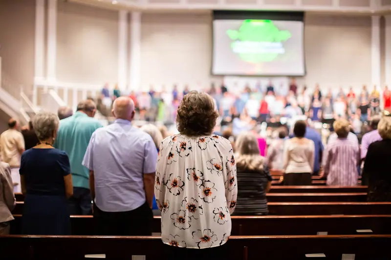 The congregation standing for a hymn