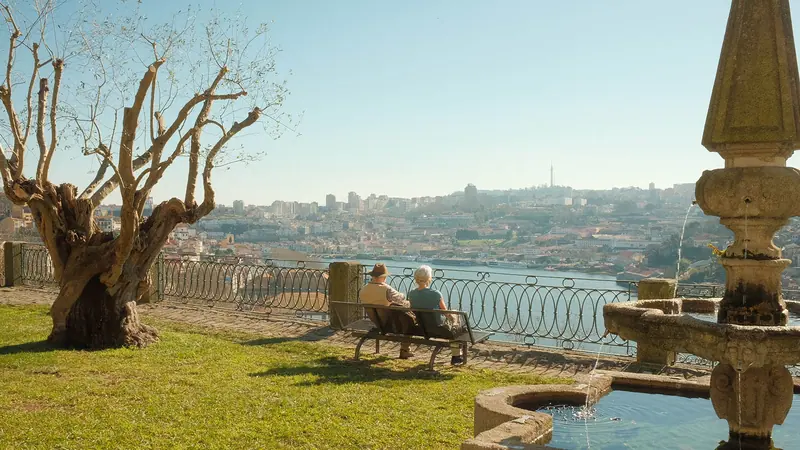 A couple on a bench above the river