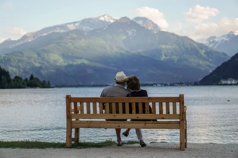 A couple on a bench by the lake