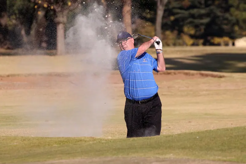 A resident blasting out of a bunker at the golf course
