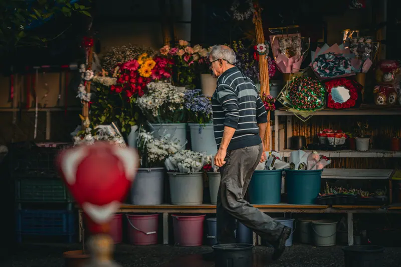 A resident passing the flower stall