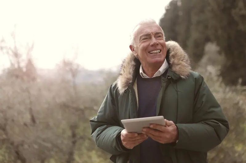 A resident reading on his tablet outdoors