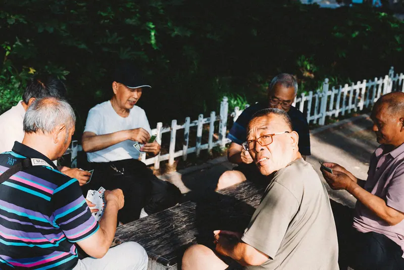 Residents playing cards at the courtyard tables