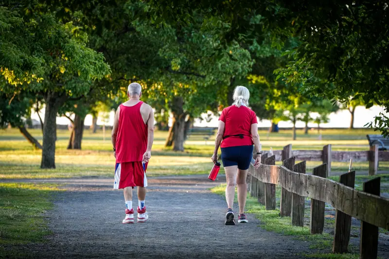 Two residents out for a walk on the park path