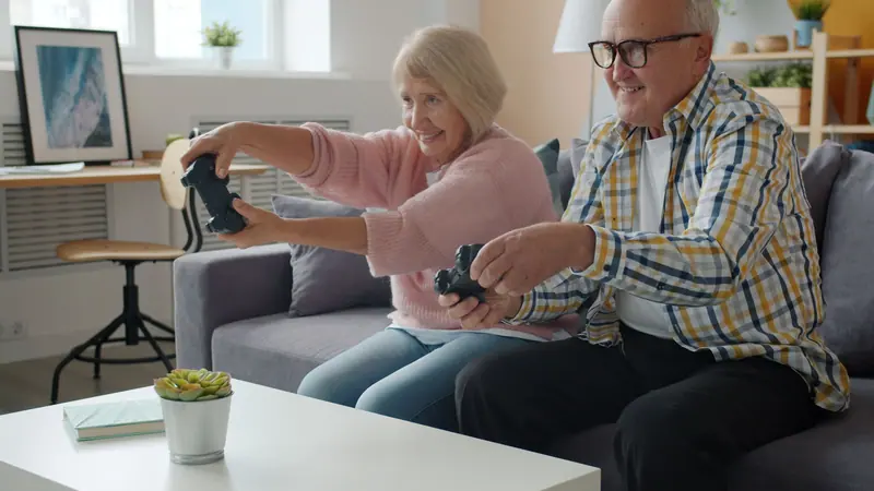 A couple laughing over a video game in their apartment