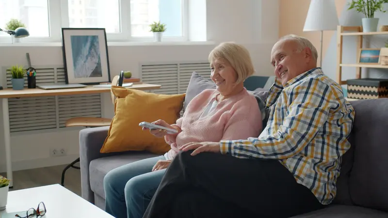 A couple laughing together in their living room