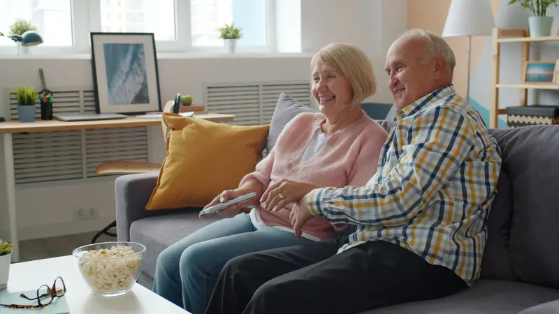 A couple watching the game together on the couch