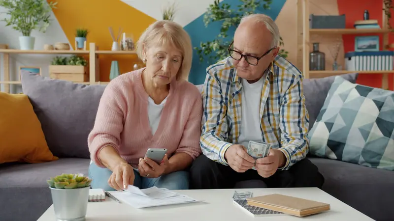 A couple going over the bills at the kitchen table