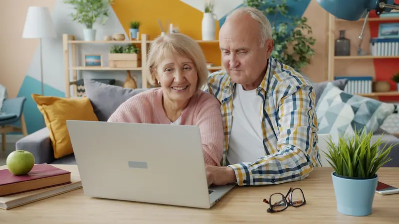 A couple browsing old photos on the laptop
