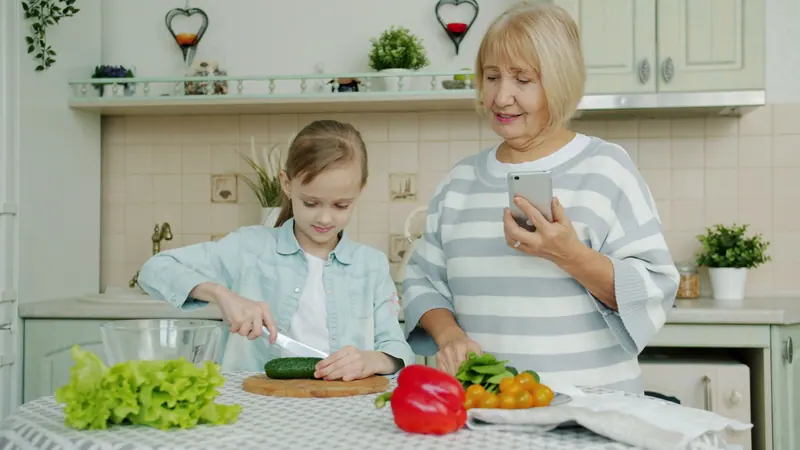 A grandmother and granddaughter preparing vegetables