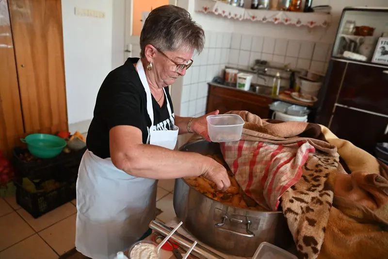 A resident putting up pickles and sauerkraut
