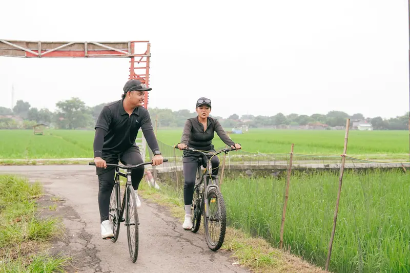 A couple cycling the county road