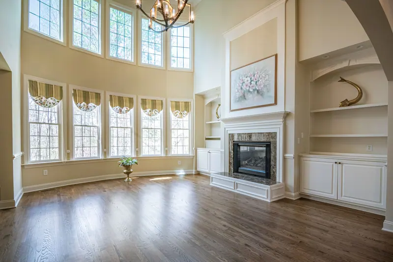 The great room with its fireplace and two stories of windows