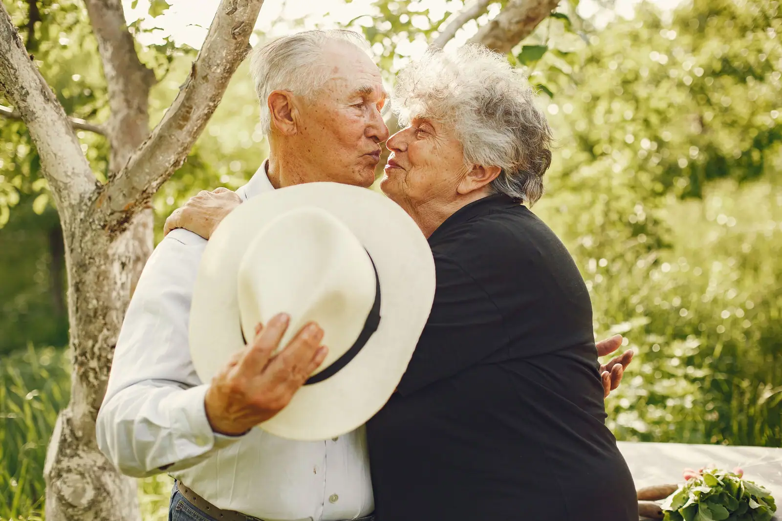 A couple sharing a kiss in the garden