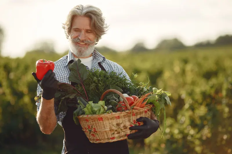 A resident gathering vegetables in the garden