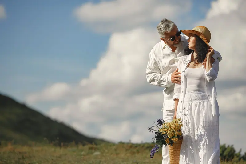 A couple picking wildflowers on the hill