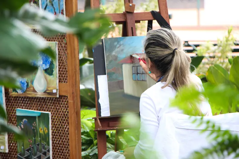 A resident painting in the garden