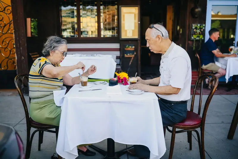 A couple with coffee outdoors