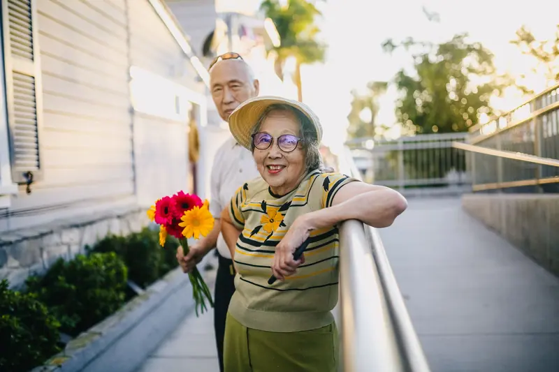 A couple strolling the walking loop with flowers from the garden