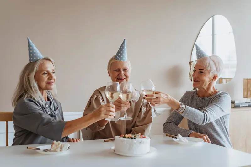 Three friends toasting a birthday