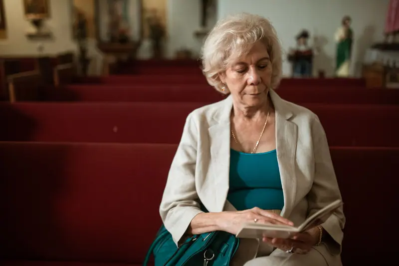 A resident reading quietly in the chapel