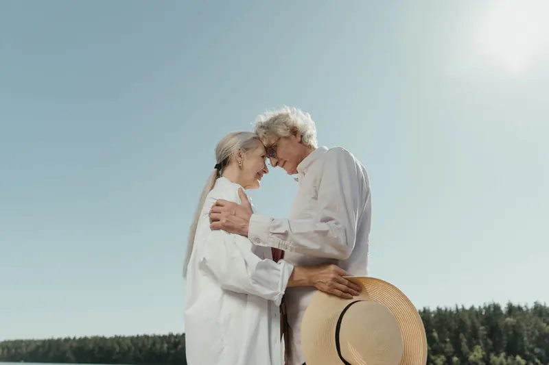 A husband and wife embracing on the bluff