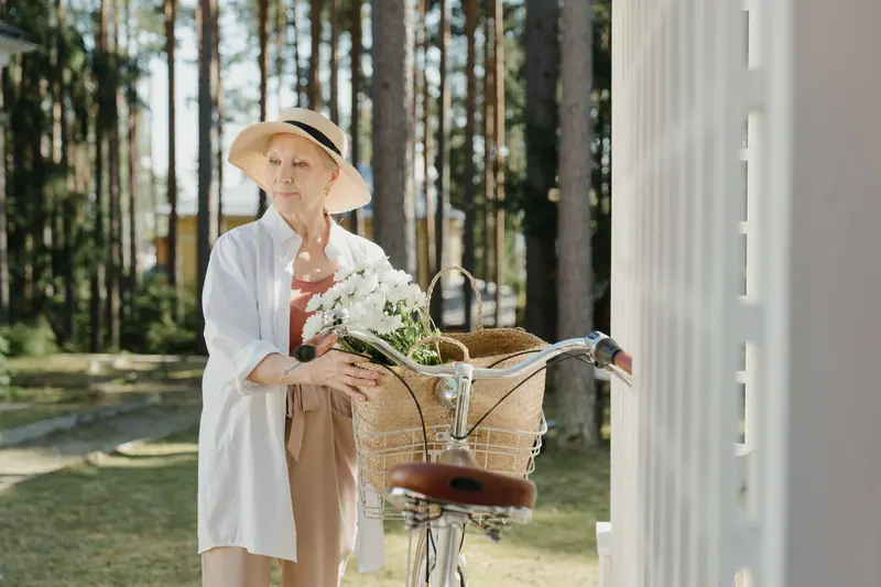 A resident with flowers in her bicycle basket