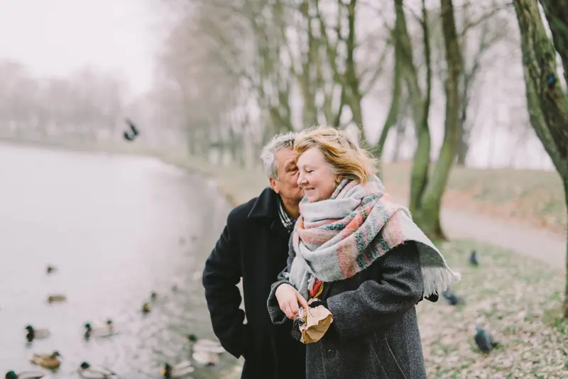 A couple walking by the lake in winter