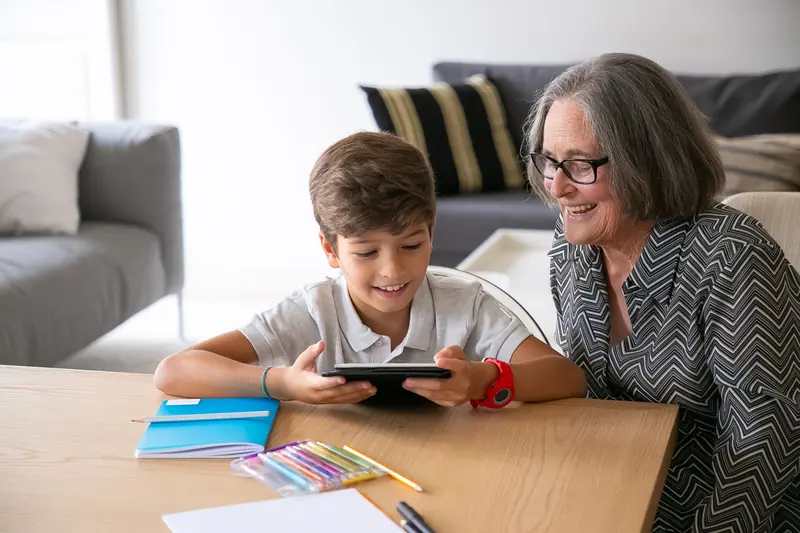 A grandmother and grandchild with a tablet