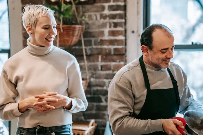 A couple cooking together at home