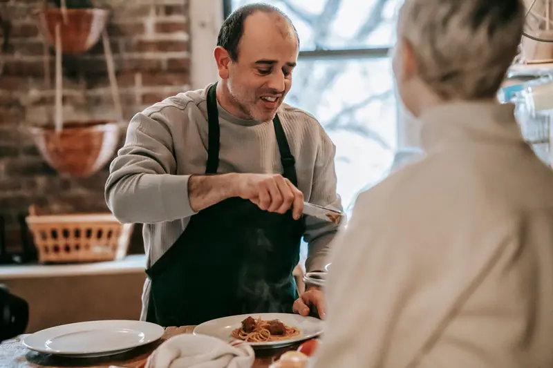 A couple serving homemade pasta