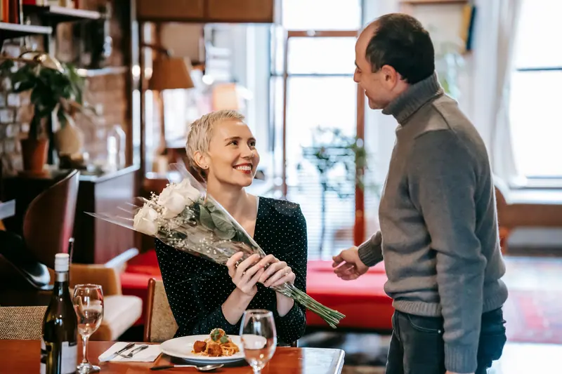 A resident accepting flowers at her birthday dinner