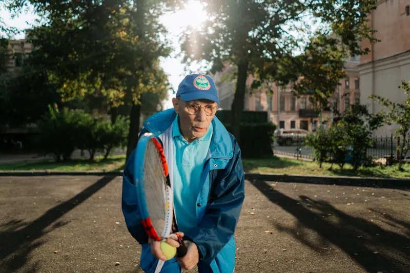 A resident playing tennis