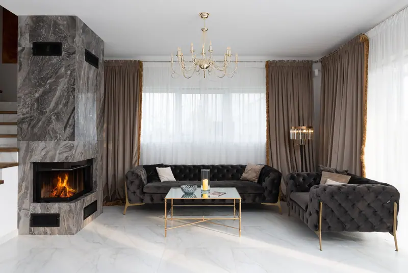 Sophisticated living room with a fireplace, elegant decor, and plush couches, offering a cozy ambiance.