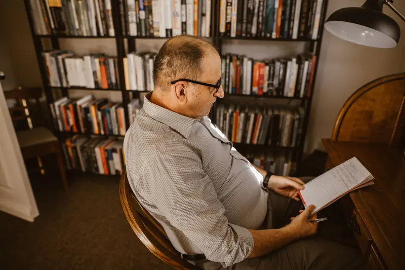 A resident reading in a leather chair